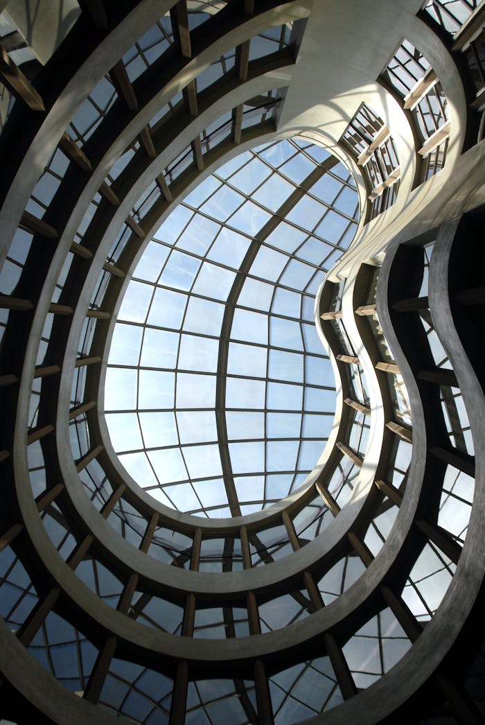 who-we-are A stunning view of a contemporary architectural glass ceiling with a unique spiral design.